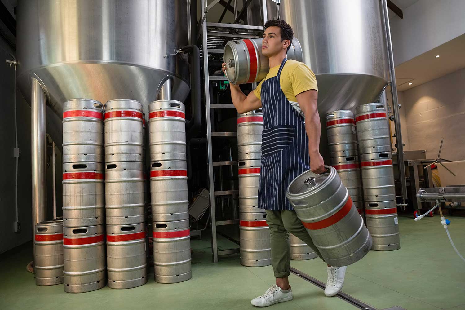 worker-with-kegs-walking-at-warehouse