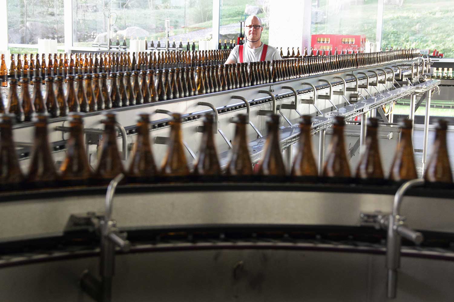 Beer bottles on production line in brewery
